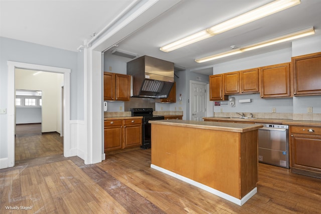 kitchen with extractor fan, electric range, light countertops, stainless steel dishwasher, and a center island