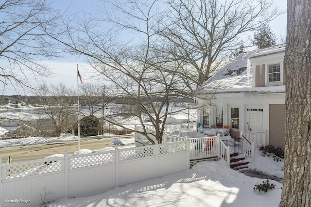 yard layered in snow with fence