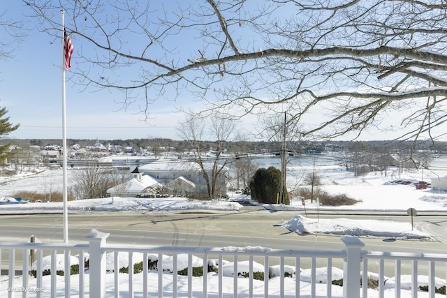 snowy yard featuring fence