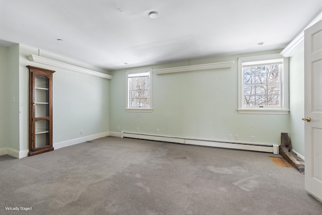 interior space featuring a baseboard heating unit, light carpet, and baseboards