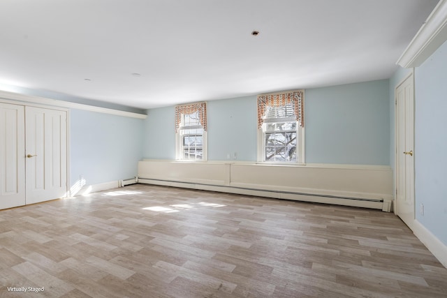 interior space featuring light wood-type flooring and baseboard heating