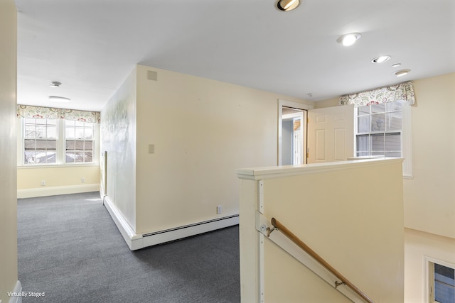 hall with baseboards, dark carpet, an upstairs landing, a baseboard heating unit, and recessed lighting