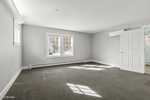 empty room with plenty of natural light, dark colored carpet, baseboard heating, and a wall mounted air conditioner