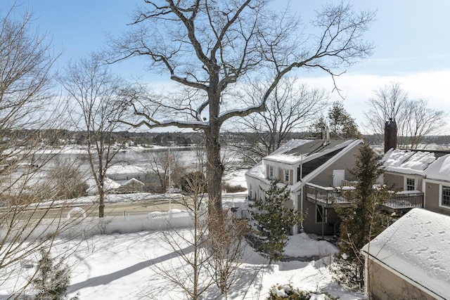 view of snow covered exterior with a chimney