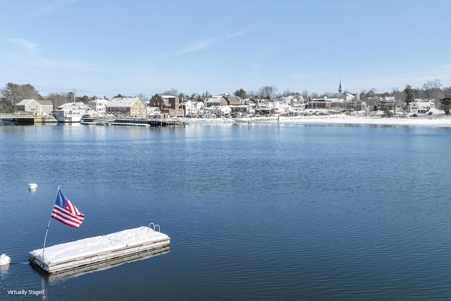 view of dock with a water view and a residential view