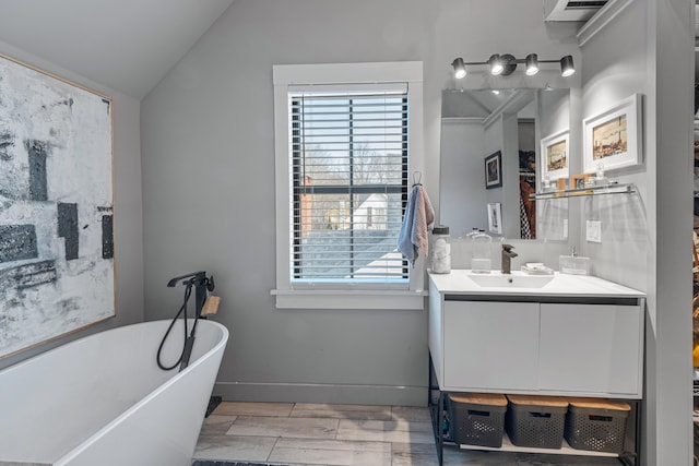 bathroom featuring vanity, a healthy amount of sunlight, a bath, and vaulted ceiling