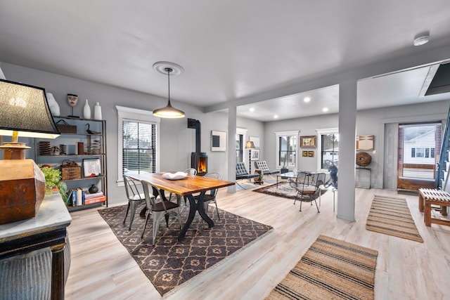 dining room featuring a wood stove and light hardwood / wood-style flooring