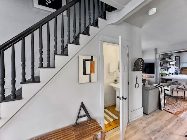 stairway with hardwood / wood-style floors