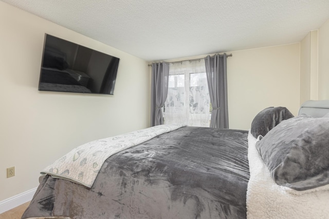 bedroom featuring a textured ceiling and wood-type flooring