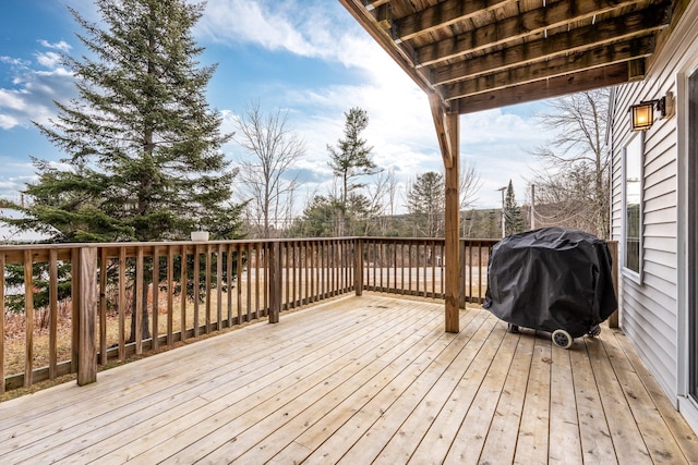 wooden deck featuring a grill