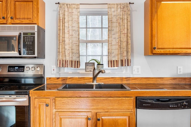 kitchen with sink and appliances with stainless steel finishes