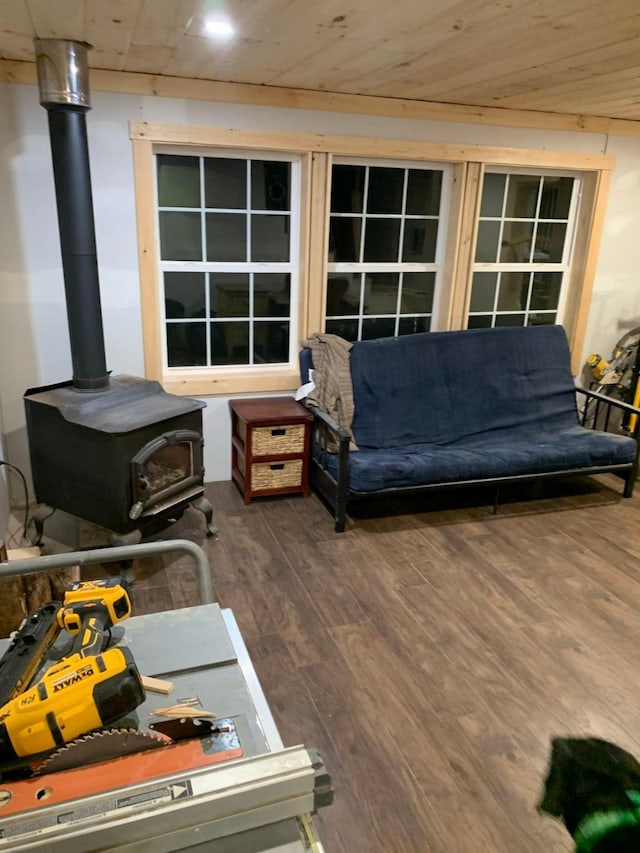 living room with wood-type flooring, a wood stove, and wood ceiling