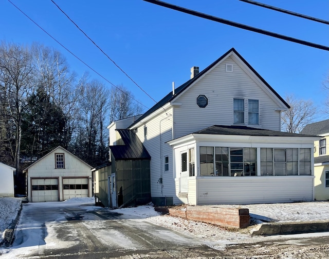 view of property exterior featuring an outbuilding and a garage