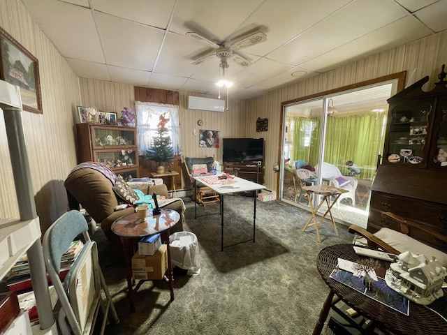 carpeted living room featuring a wall mounted AC, ceiling fan, and a baseboard heating unit