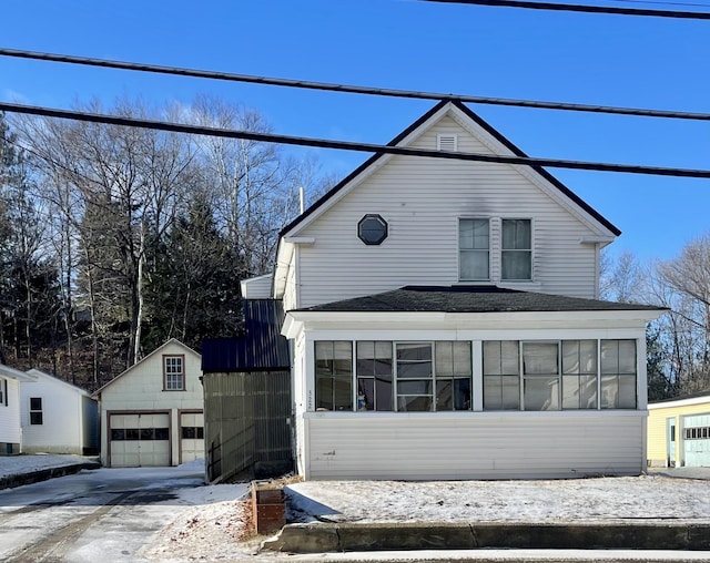 view of front facade featuring an outdoor structure and a garage