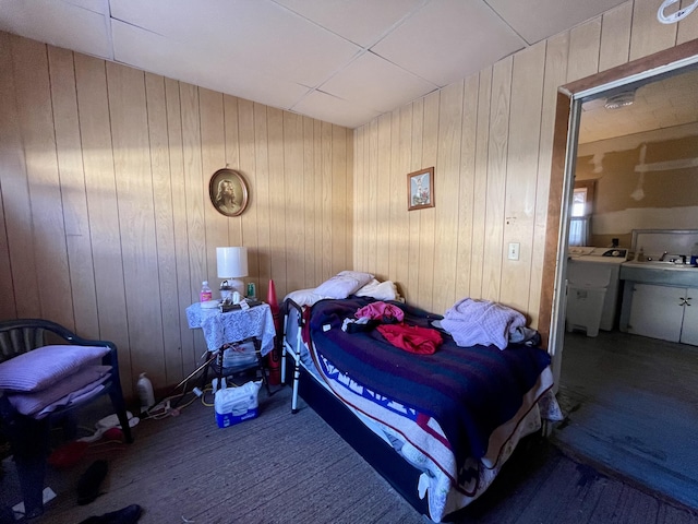 bedroom featuring wooden walls