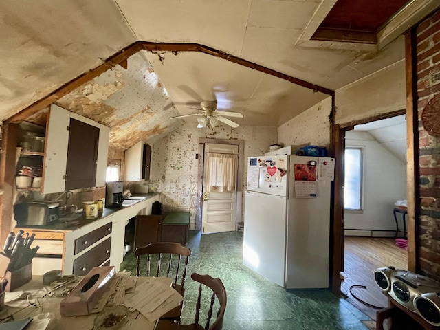 kitchen featuring white fridge, vaulted ceiling, ceiling fan, and a baseboard radiator