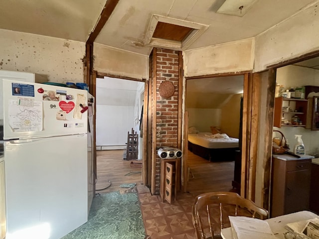 kitchen with white fridge and a baseboard radiator