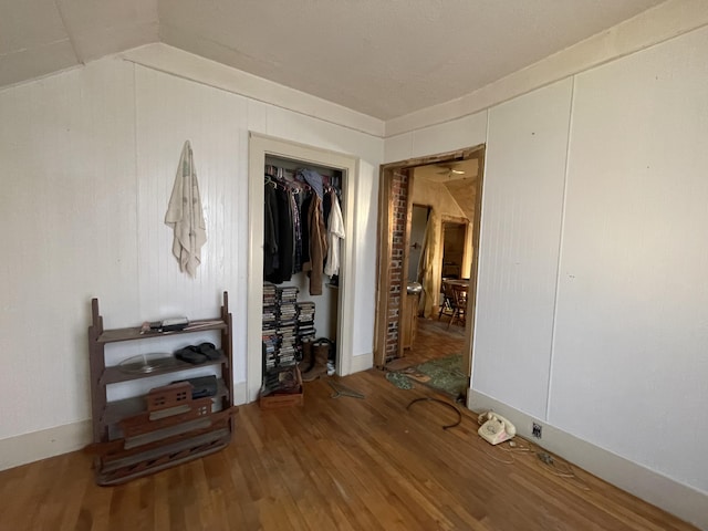 interior space featuring wood-type flooring and lofted ceiling