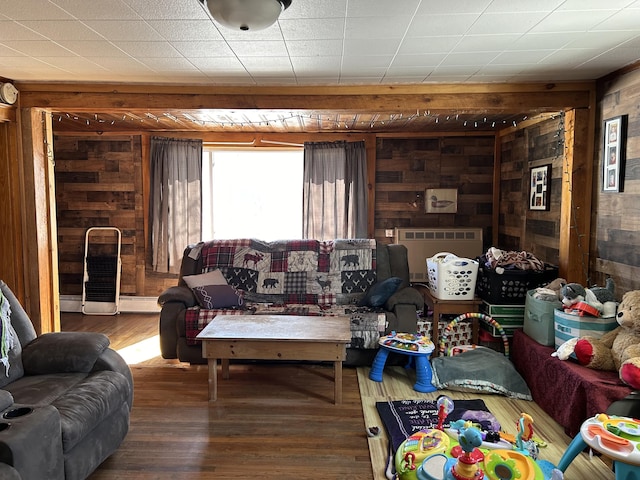 living room with hardwood / wood-style floors and wooden walls