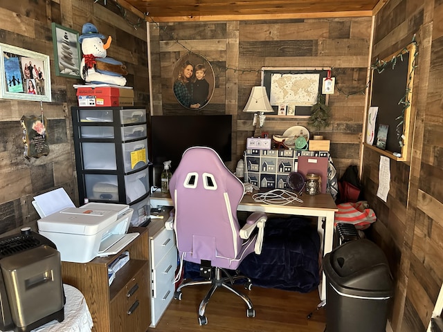 home office featuring hardwood / wood-style flooring and wood walls