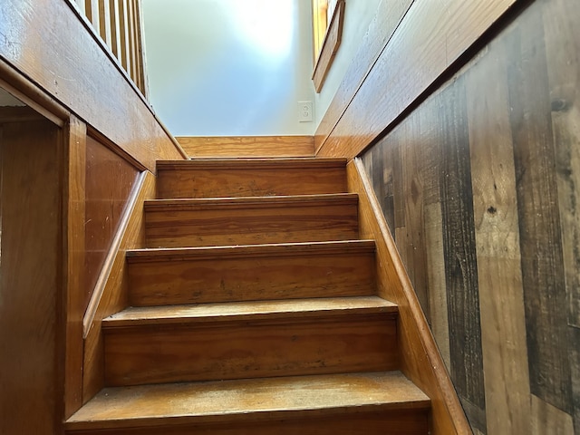 stairway with wood walls