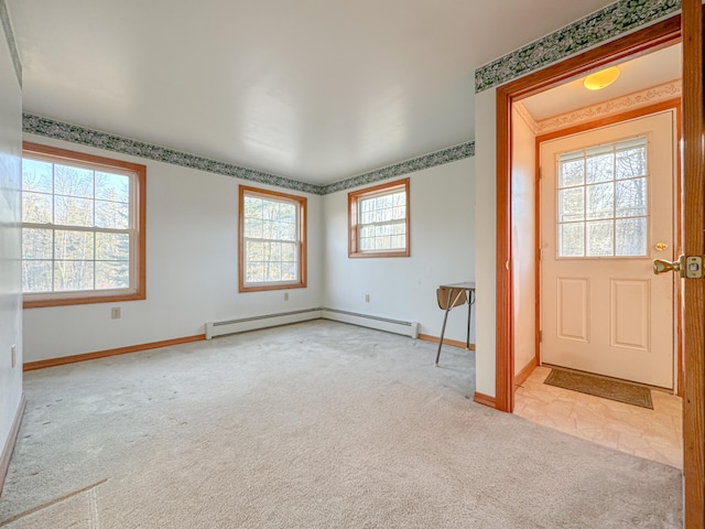 carpeted entryway with baseboard heating and plenty of natural light