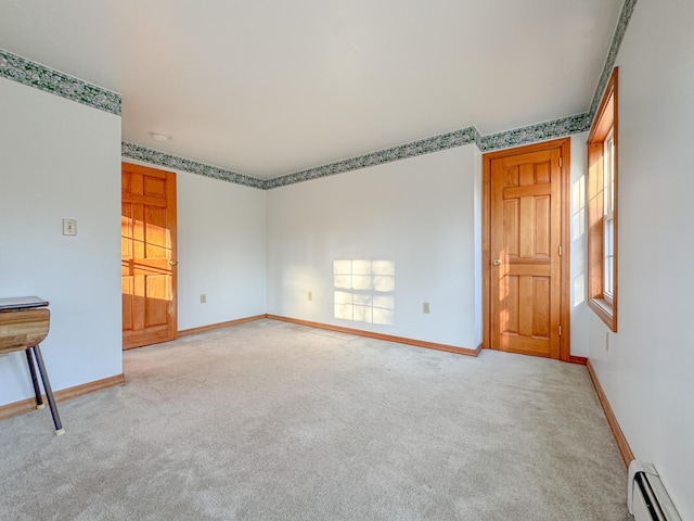 carpeted empty room with baseboard heating