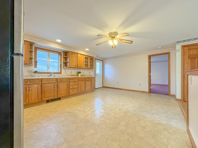 kitchen featuring stainless steel fridge, plenty of natural light, ceiling fan, and sink