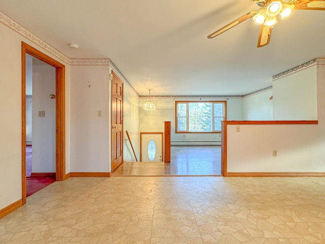 empty room featuring ceiling fan with notable chandelier and baseboard heating