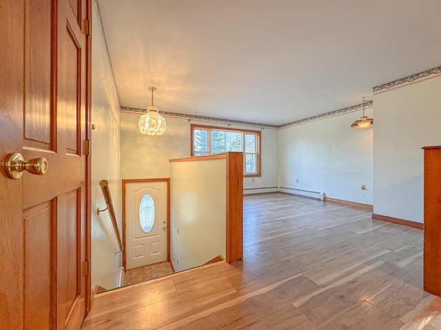 foyer featuring hardwood / wood-style flooring, an inviting chandelier, and a baseboard radiator