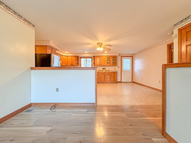 kitchen featuring ceiling fan, stainless steel fridge, light hardwood / wood-style floors, and crown molding