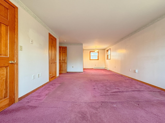 empty room featuring light colored carpet, baseboard heating, and crown molding