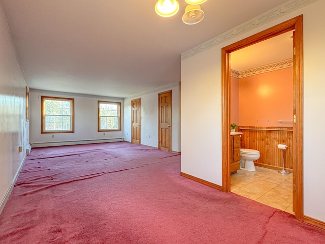 interior space featuring light colored carpet, ensuite bath, baseboard heating, and ornamental molding