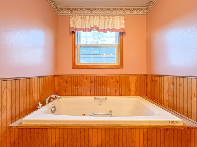 bathroom with a bathing tub and wooden walls