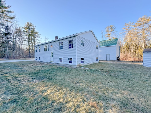 view of side of home with a yard