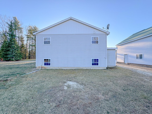 view of side of home featuring a yard