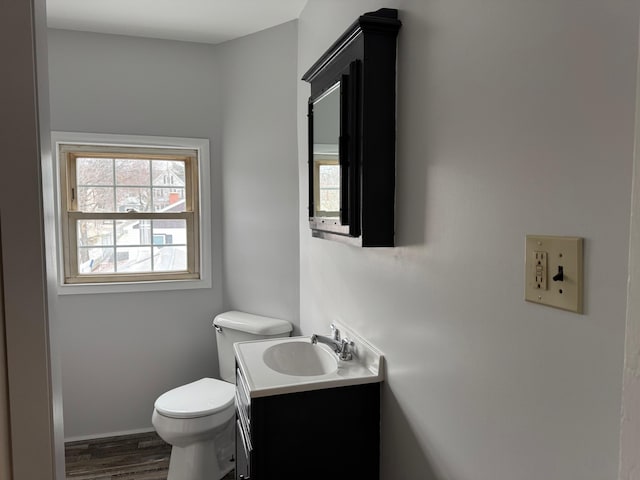 bathroom with vanity, toilet, and wood-type flooring