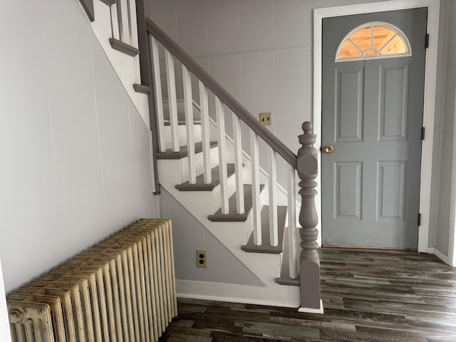 entrance foyer featuring radiator heating unit and dark hardwood / wood-style floors