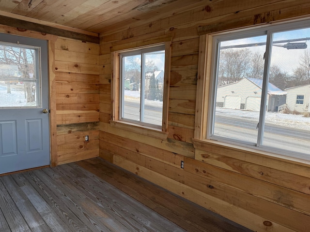 entryway featuring hardwood / wood-style floors, wooden ceiling, a wealth of natural light, and wooden walls