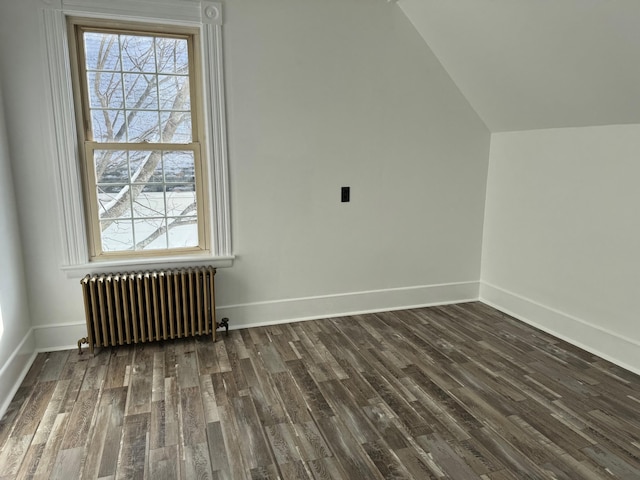 bonus room with dark wood-type flooring, radiator, and lofted ceiling