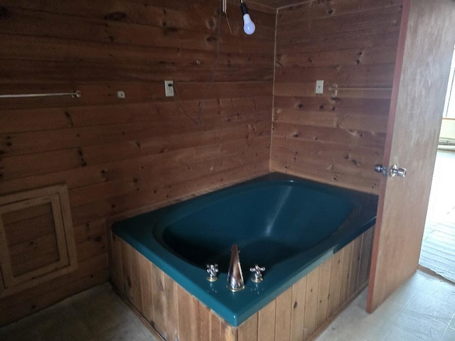 bathroom with wood walls and a tub to relax in