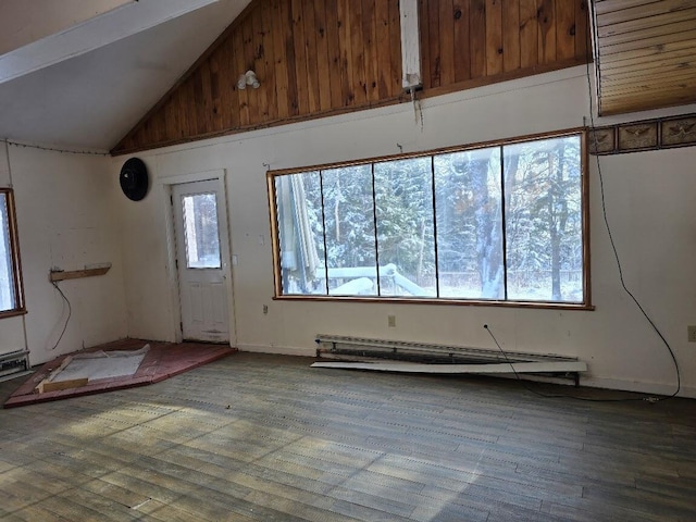 interior space featuring baseboard heating, wood-type flooring, and vaulted ceiling