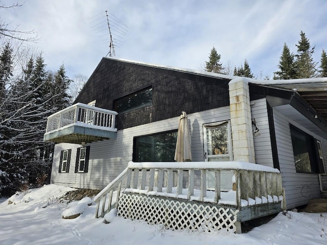 view of snow covered exterior with a balcony