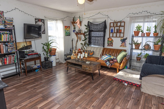 living room with ceiling fan and dark wood-type flooring