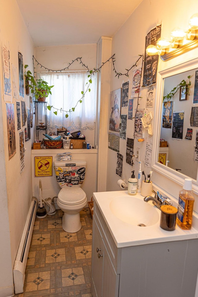 bathroom with vanity, a baseboard radiator, and toilet