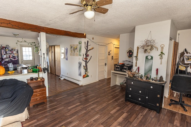 interior space with a textured ceiling, ceiling fan, a baseboard radiator, and dark hardwood / wood-style floors