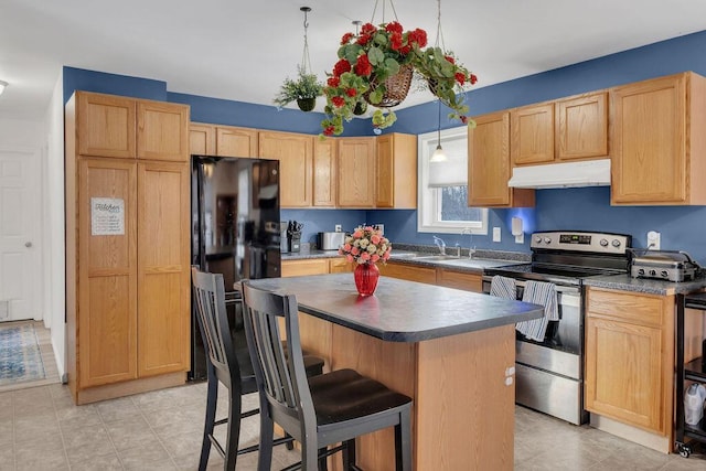 kitchen with a center island, hanging light fixtures, a breakfast bar, black refrigerator, and stainless steel electric range