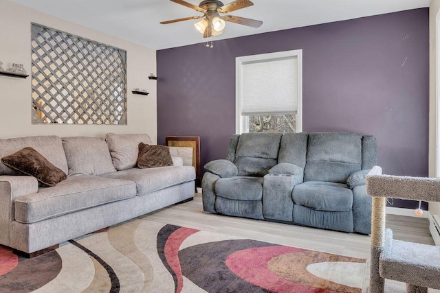 living room featuring ceiling fan and light wood-type flooring