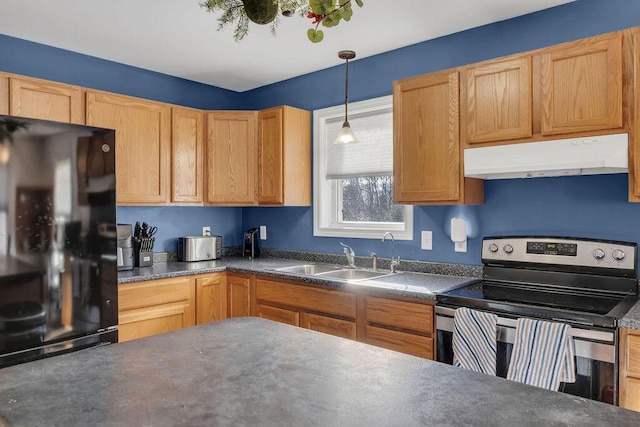 kitchen featuring black fridge, electric range, decorative light fixtures, and sink